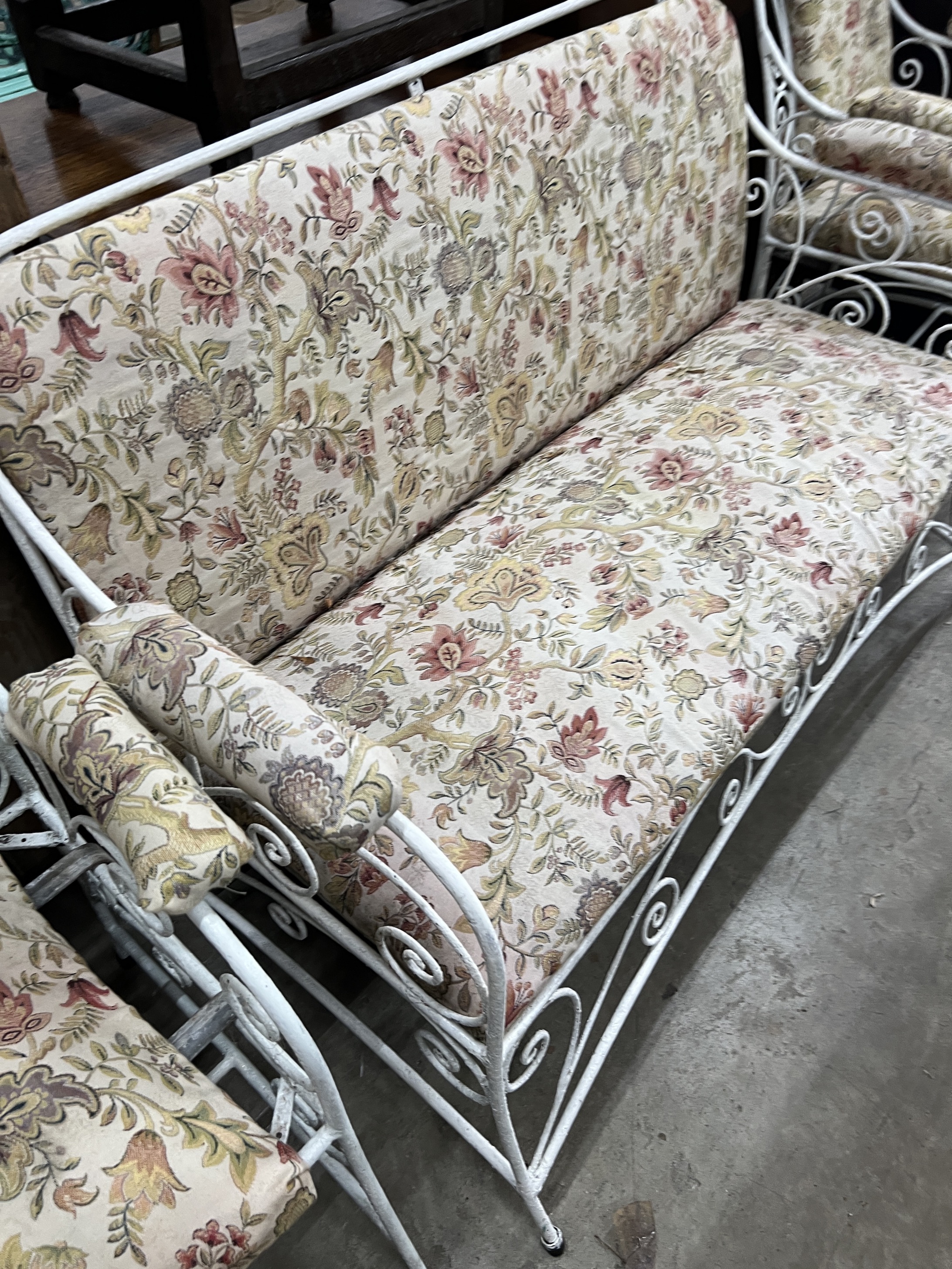 A painted wrought iron upholstered three piece suite, settee length 130cm, width 56cm, height 83cm